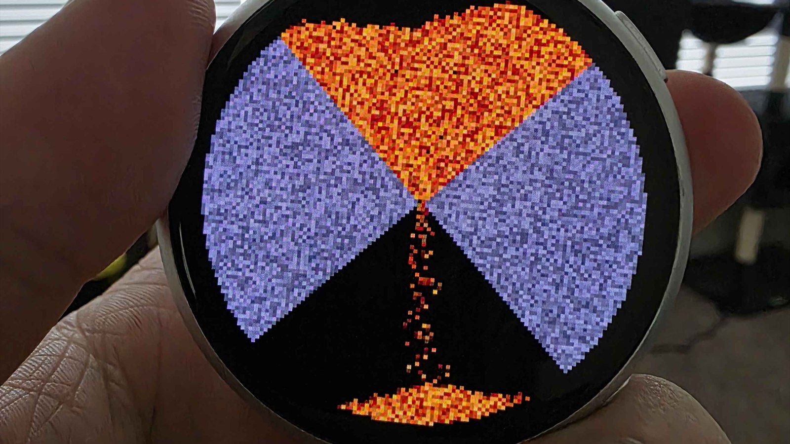 esp_sand_sim on the round ESP32-S3 AMOLED: an hourglass scene with sand pouring through the neck